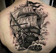 a man with a ship tattoo on his back