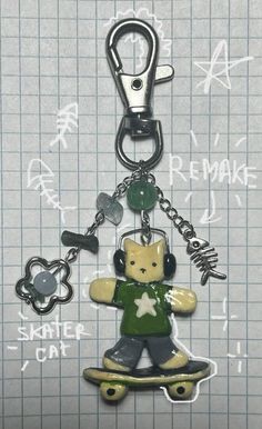 a key chain with a teddy bear on it and various keys hanging from it's sides