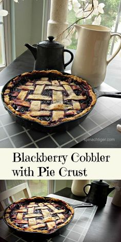 blackberry cobbler with pie crust in a pan on a counter next to a coffee pot