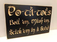 a black and gold sign with writing on it