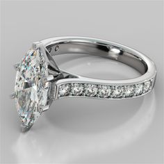 an oval cut diamond engagement ring with channeled diamonds on the band and side stones