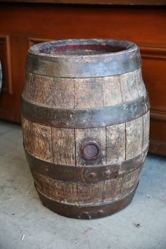 an old wooden barrel sitting on the ground