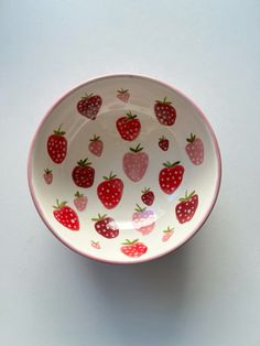 a bowl with strawberries painted on it