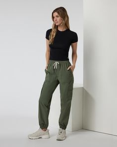 The new Birch Joggers exude utility. Versatile, durable and easy to wear, they’re built with a quick-dry stretch woven designed to go from running errands to tackling trails in a heartbeat. You’ll love their flattering fit that features a high rise and a relaxed cut through the hip and legs. | Vuori Birch Jogger Pants | Army/Green | XS Vuori makes premium performance apparel inspired by the active Coastal California lifestyle; an integration of fitness, surf, sport, and art. Breaking down the bo Casual Workout Pants With Functional Pockets, Sporty Parachute Pants With Elastic Waistband For Work, Athleisure Activewear With Cargo Pockets, Sporty Midweight Cargo Pants With Side Pockets, Athleisure Nylon Cargo Pants With Functional Drawstring, Nylon Athleisure Cargo Pants With Functional Drawstring, Athleisure Tapered Leg Cargo Pants For Outdoor, Functional Midweight Cargo Pants With Elastic Waistband, Casual Bottoms With Functional Pockets In Recycled Polyester