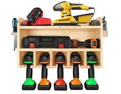 a wooden shelf filled with lots of different types of power tools and drillers on top of each other