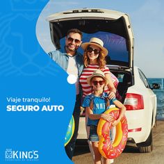 two adults and a child standing in front of a car with the back door open