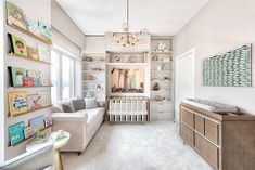 a baby's room with a crib in the corner and shelves on the wall