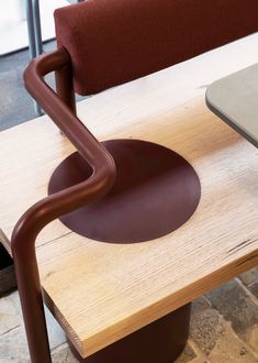 a wooden table topped with a metal chair