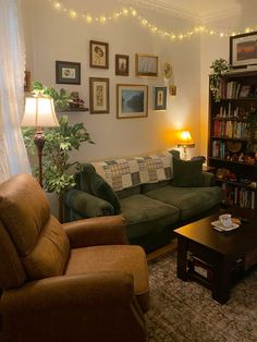 a living room with two couches and a coffee table in front of a bookshelf