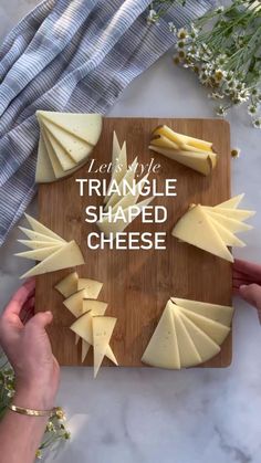 someone cutting cheese on a wooden board with the words triangle shaped cheese written in white