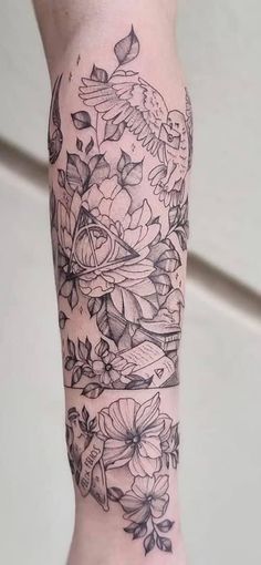 a woman's arm with flowers and birds on it