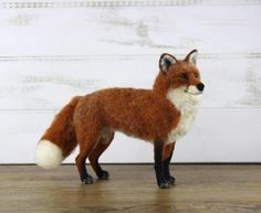 a toy fox standing on top of a wooden floor