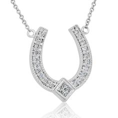 Introducing the Designer Diamond Horseshoe Pendant, a stunning symbol of good luck and elegance. Crafted from 14K white gold, this horseshoe pendant measures 16mm tall (6/10 inch) and 13mm wide (5/10 inch), making it a beautiful and eye-catching accessory. The pendant comes with a 14K white gold chain, available in either a 16 or 18-inch length, adding to its versatility and wearability. Adorned with round-cut diamonds and one princess-cut diamond, the pendant sparkles with a total diamond weigh Luxury Horseshoe-shaped Formal Jewelry, Luxury Horseshoe Jewelry For Formal Occasions, Classic Horseshoe Jewelry, White Gold Horseshoe Jewelry For Anniversary, Formal Horseshoe Jewelry With Diamond Accents, Formal Horseshoe Diamond Jewelry, Elegant Sterling Silver Horseshoe Jewelry, Classic Horseshoe Jewelry With Diamond Accents, Classic Horseshoe Diamond Accents Jewelry