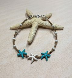 "I love the beachy vibes of this boho summer anklet!  It was created using turquoise and white howlite stone starfish beads, along with Czech glass rondelles, and seed beads. Anklet closes with a lobster clasp, and is adjustable with a 1\" extender chain. Anklet measures 9\" to 10\" with the extender chain. Thank you for shopping with The Lucie Collection!" Diy Anklets, Beads Anklet, Starfish Anklets, Leather Anklets, Stone Bead Jewelry, Beaded Ankle Bracelets, Ocean Inspired Jewelry, Vintage Inspired Earrings, Beachy Jewelry