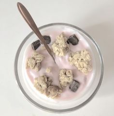 a bowl filled with yogurt and cookies on top of a white countertop