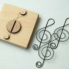 a wooden stamp with music notes on it and a pair of scissors next to it