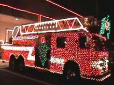 a red fire truck decorated with christmas lights