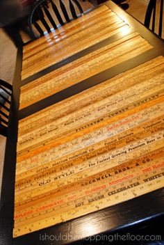 the table is made out of wood and has writing on it, along with two chairs