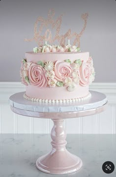 there is a pink cake with flowers on it