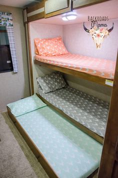 bunk beds in a small room with pink walls