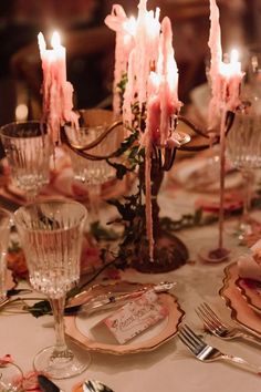 the table is set with candles and dishes