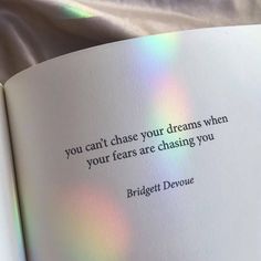 an open book with the words you can't chase your dreams when your fears are chasing you