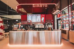 the interior of a restaurant with red and white balloons