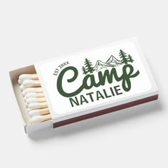 a box of matches with camp natale written on the front and back in green ink