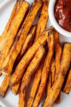 baked french fries on a plate with ketchup