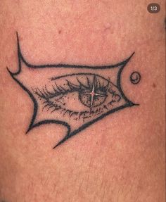 a close up of a person's leg with an eye tattoo on the side