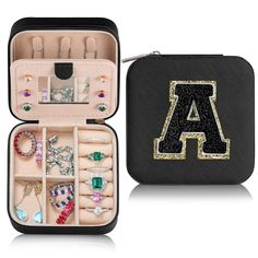 an open black case filled with lots of jewelry