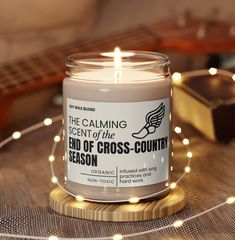 a candle that is sitting on a table next to some string lights and a guitar