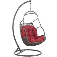 a swing chair with a red cushion on it