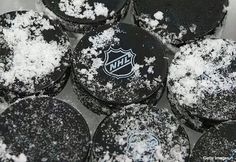 black and white cupcakes covered in powdered sugar with the logo of the hockey team