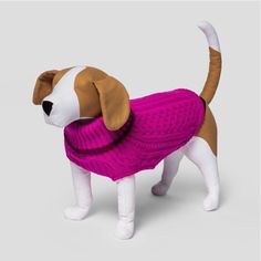 a stuffed dog wearing a pink sweater