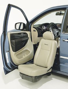 the interior of a blue minivan with its door open