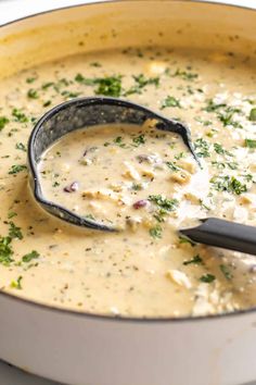 a ladle is being used to stir the soup