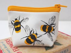 This is a really cute little coin purse in soft white leather screen printed all over with black and yellow bumble bees. This coin purse is really petite, but due to its three dimensional shape you can squeeze all sorts of goodies in - coins, notes, lipstick. It's ideal for protecting precious items from scratches.  It would make a great gift for a mum who wants to organise their bag. The distinctive design makes it really easy to spot in a full handbag.  Gift wrap is available in a black envelo Charger Pouch, Screen Printing Frame, Leather Makeup Bag, Black Envelopes, Small Coin Purse, Bumble Bees, Leather Decor, Bee Gifts, Bee Print