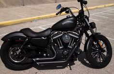 a black motorcycle parked in a parking lot