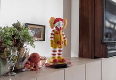 there is a statue of a clown on top of a shelf in the living room