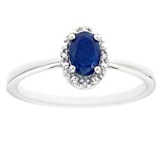 a white gold ring with a blue sapphire and diamonds