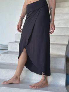 Unleash your inner boho chic with our Layer Wrap Skirt. Its versatile design allows you to wear it dressed up or dressed down with a tee. The fitted silhouette features a slit that can be worn in the front, side, or back, offering endless styling possibilities. Lightweight and perfect for resort wear, pair it with heels, flip-flops, boots, or sneakers. Color: Black Sizes: S/M and M/L Hips: S/ 35"-37" M/ 37"-39" L/ 39"-41" 90% Rayon 10% Spandex Layer Wrap Skirt with Slit - Can be worn reversed Ma Easy Silhouette, Cream Outfits, M And M, Layer Skirt, Jewel Tone Colors, Layered Skirt, Draped Fabric, Fitted Skirt, Skirt Design