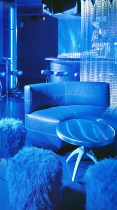 a living room filled with furniture and blue lighting