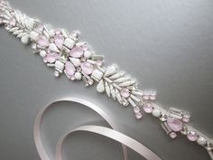 "This beautiful unique bridal belt features Swarovski crystal design with the mix of powder rose, chalk white and clear crystals. This belt measures 16 1/4\" long and the center of the belt measures 1 7/8\" wide. The belt is made with 3/8\" wide double face satin ribbon in ice pink color. Also available with white, off white or ivory ribbon. The entire sash measures 150\" long. Silver finish only." Pink Bridal Belt With Sashes For Party, Elegant Pink Bridal Belt With Sashes, Pink Sashes Bridal Belt For Wedding, Adjustable Bridal Belt With Sashes For Party, Adjustable Sashes Bridal Belt For Party, Crystal Bridal Belt With Sashes For Party, Elegant Pink Bridal Belt For Wedding, Bridal Sash Belt, Wedding Belt