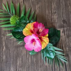 flowers and leaves are arranged on a wooden table