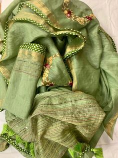 Kindly Check the availability of this product before placing the order Update! - Zynah covered by LBB - https://lbb.in/bangalore/zynah-designs-handloom-sarees/ Pure Tussar Linen Saree with Hand Embroidery. It features beautiful floral designs in different subtle shades. Embroidered motifs are crafted all over the pallu and body of the saree. Borders of the saree are beautifully weaved in golden zari which adds to the elegance of the saree The saree is lightweight and easy to drape, Comes with fa Pista Green Embroidered Blouse Piece For Festivals, Festival Blouse Piece In Pista Green With Embroidered Border, Green Cotton Lehenga With Resham Embroidery, Green Cotton Silk Traditional Wear With Embroidered Border, Green Cotton Silk Set With Intricate Embroidery, Green Cotton Silk Sets With Embroidered Border, Green Chanderi Lehenga With Embroidered Border, Fitted Raw Silk Dupatta With Embroidered Border, Green Traditional Wear With Embroidered Cotton Silk