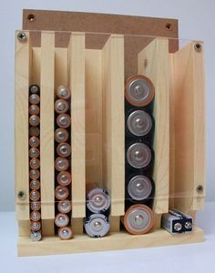 an assortment of batteries in a wooden holder