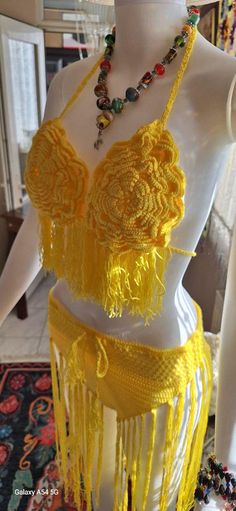 a mannequin is dressed in yellow and beads