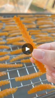 someone is peeling orange peels on a grill with their thumb and thumbnails