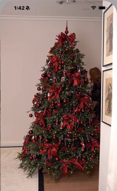 a christmas tree with red bows and decorations